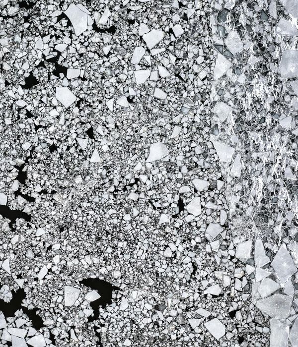 Abstract arctic sunrise over frozen geometric shapes